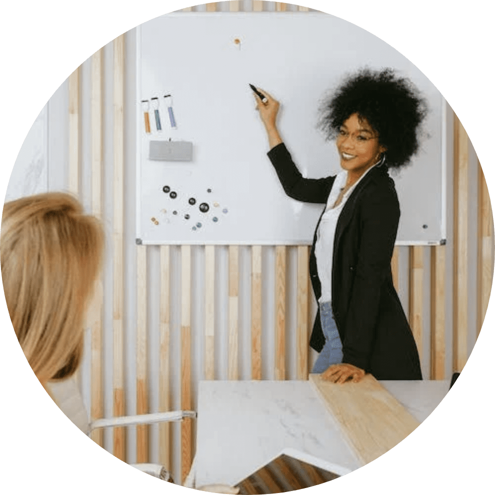 A woman standing in front of a whiteboard.