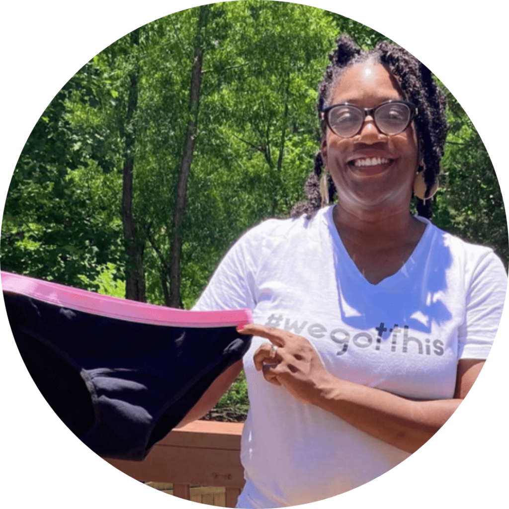 A woman holding onto a pink frisbee